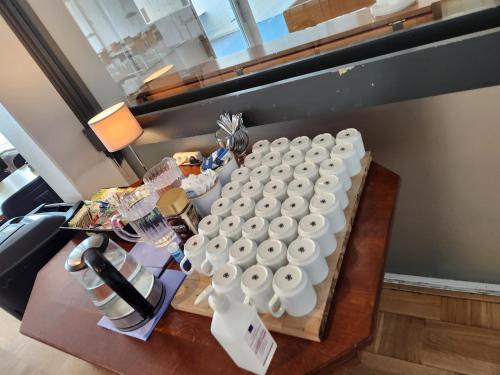 a table with a bunch of white plates on it at Hotel Østersø in Aabenraa