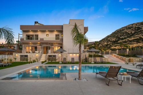 a house with a swimming pool in front of a house at Kayy Apartments 4 in Matala in Matala