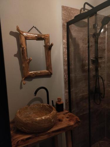 a bathroom with a sink and a mirror on a table at Vadilife suit in Çamlıhemşin