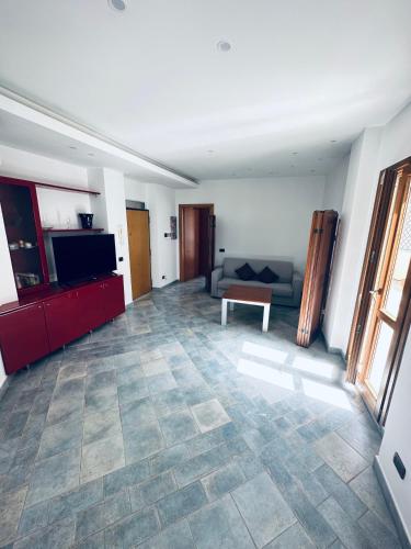 a living room with a couch and a table at NEWHOUSE VICTORIA - Sea View Apartment in Nettuno