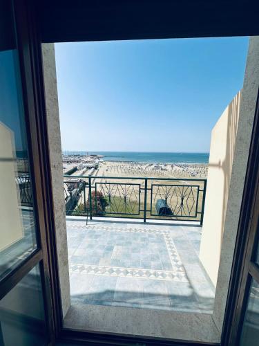 a view of the beach from a window at NEWHOUSE VICTORIA - Sea View Apartment in Nettuno
