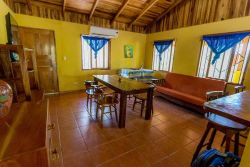 a living room with a couch and a table and chairs at Casa de la Naturaleza in Cóbano