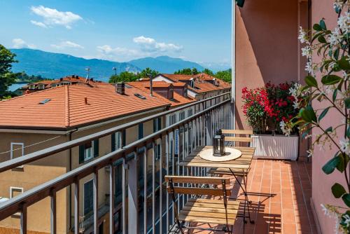 a balcony with chairs and a table on a building at Labiena Lake Maggiore in Laveno