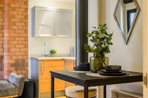 a table with a plant on it in a kitchen at Host & Stay - Queen Square Apartment in Liverpool