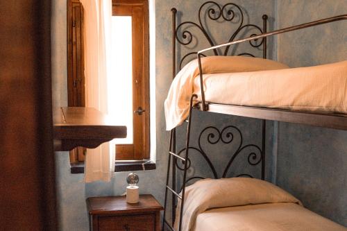 a bedroom with two bunk beds and a window at Locanda Le Tre Sorelle in Casal Velino