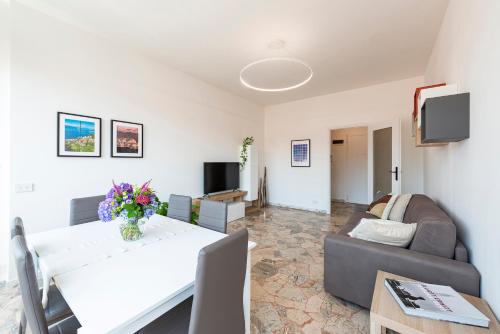 a living room with a white table and a couch at Labiena Lake Maggiore in Laveno