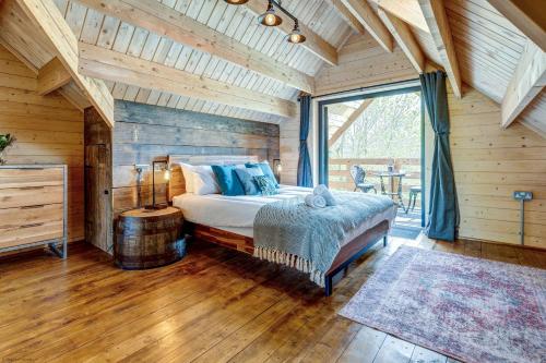 a bedroom with a bed and a large window at Buttercup Lodge in Benson