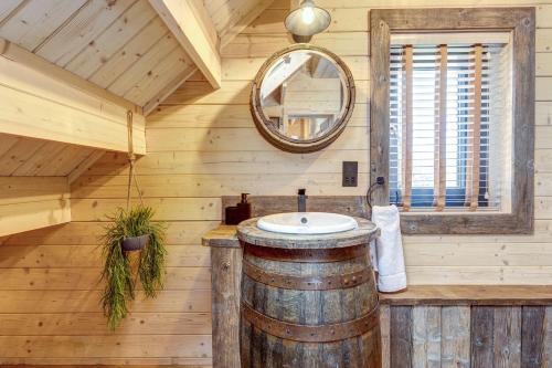 a bathroom with a sink in a wooden cabin at Buttercup Lodge in Benson