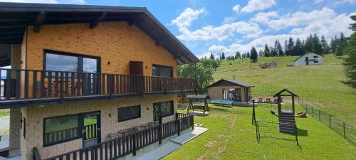 a house with a yard with a playground at Noor in Vatra Dornei