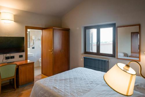 Кровать или кровати в номере Hotel La Scottiglia e Ristorante
