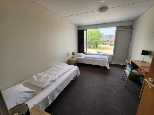 a hospital room with two beds and a window at Hotel Østersø in Aabenraa