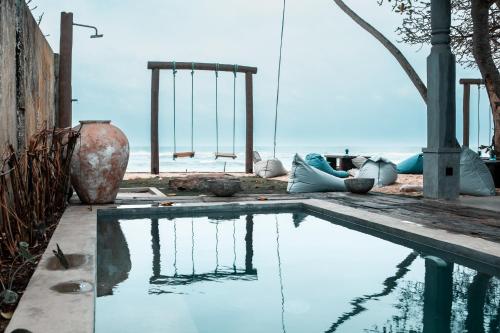 a pool of water with a view of the ocean at Moi Talpe by DBI in Talpe
