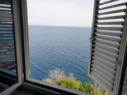 a view of the ocean from a window at VILLA BISER in Mošćenička Draga