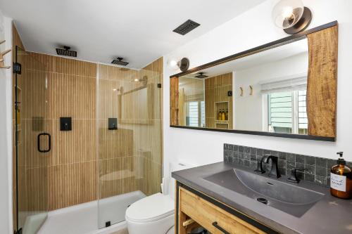 a bathroom with a sink and a toilet and a mirror at Le Chalet of Arrowbear Lake in Running Springs