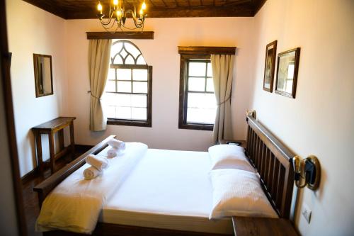 a bedroom with a bed with two towels on it at Anhel Hotel in Berat