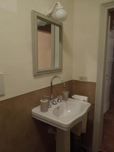 a white sink in a bathroom with a mirror at Casa Rovelli in Alfiano Natta