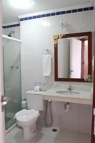 a bathroom with a toilet and a sink and a shower at Pousada Porto dos Milagres in Morro de São Paulo