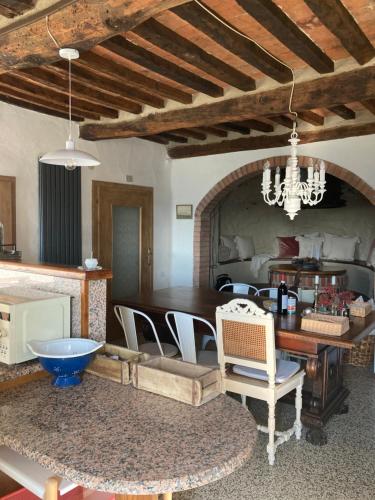 a living room with a table and a dining room at Casa di pietra in Castelnuovo di Val di Cecina