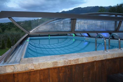 a swimming pool on the deck of a house at Pensiunea Antonia in Bran