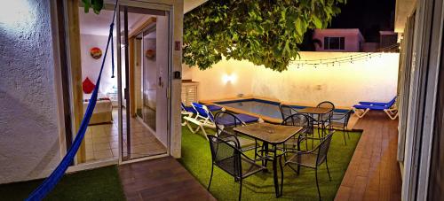 a patio with a table and chairs and a pool at 5 Bdr-ensuite Bathrooms-private Pool-golf-comfort in Cancún