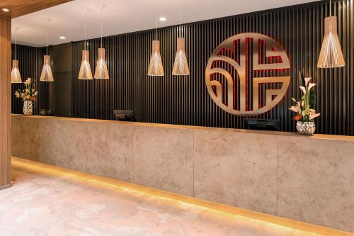 a lobby with a reception desk and a sign on the wall at NH Collection Berlin Mitte am Checkpoint Charlie in Berlin