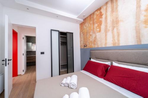 a bedroom with a large bed with red pillows at Agata in Galatina
