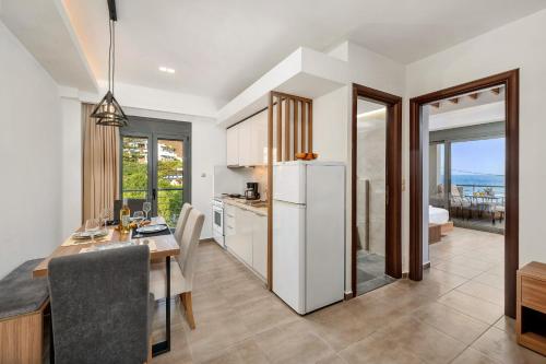 a kitchen and dining room with a table and a refrigerator at Marina apartments in Lentas