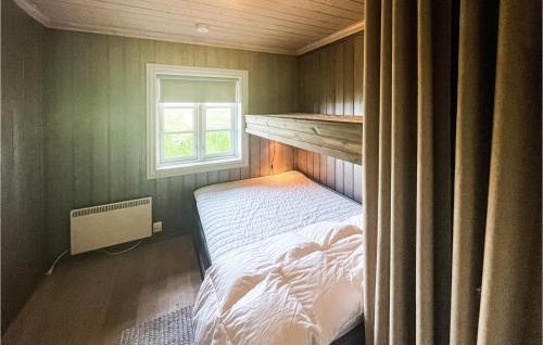 a small bedroom with a bed and a window at Beautiful Home In Uvdal With Sauna, Wifi And 5 Bedrooms in Dagali