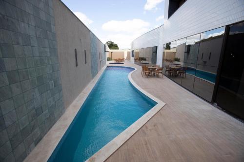 a swimming pool in the middle of a building at Nobile Hotel Araripina in Araripina