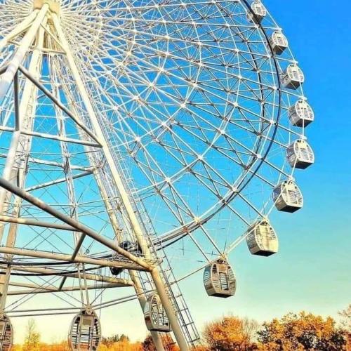 a large ferris wheel in a park at Vrnjačka Promenada - Pešačka zona - Baby friendly in Vrnjačka Banja