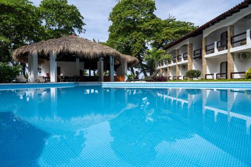 a swimming pool in front of a hotel at Fuego del Sol Beachfront Hotel in Jacó