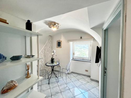 a small hallway with a table and a window at Suite Apartment con Giardino in Piazzetta in Capri