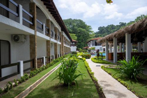 a courtyard of a building with plants at Fuego del Sol Beachfront Hotel in Jacó