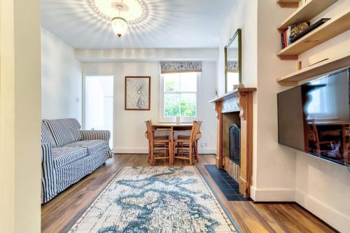 a living room with a couch and a table at Upper Fisher Row in Oxford