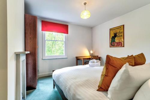 a bedroom with a large bed and a window at Upper Fisher Row in Oxford