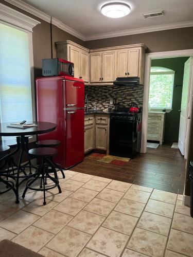 a kitchen with a red refrigerator and a table at West Wing at the Manor in Montgomery