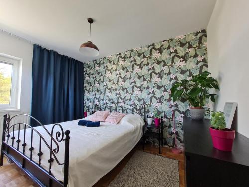 sypialnia z łóżkiem i tapetą w kwiaty w obiekcie Best Time In Graz w Grazu