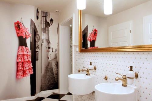 a bathroom with two sinks and a mirror at Medical Wellness & SPA Werona in Duszniki Zdrój