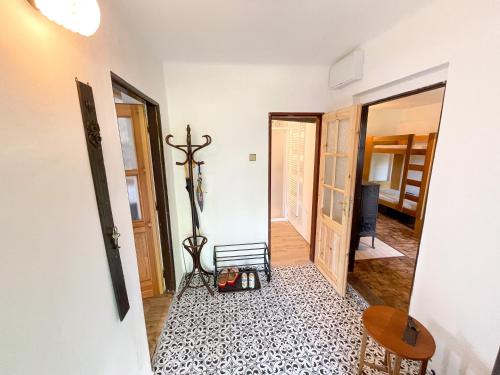 a hallway with a room with a bench and a table at Potvorovská chalupa in Potvorov