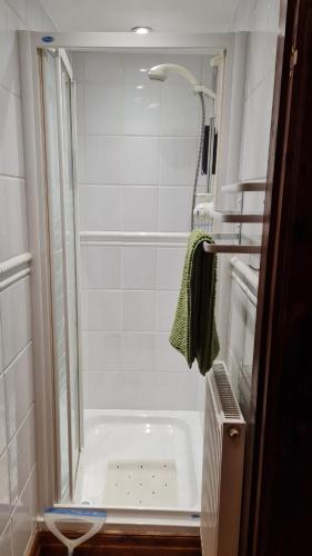 a bathroom with a shower and a bath tub at Cadshaw Country Views in Darwen