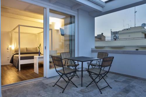 a table and chairs on a balcony with a bedroom at Bed And Breakfast T57 in Bitonto