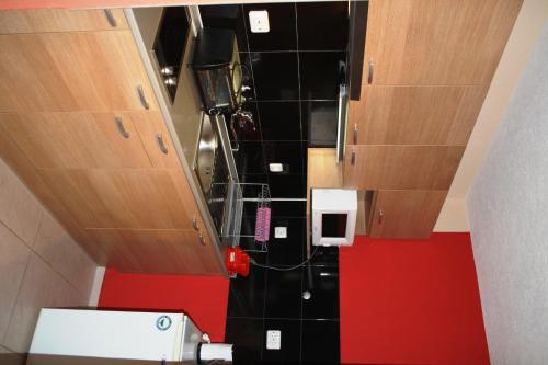 an overhead view of a bathroom with red and black tile at Zoya Guest House in Ravda