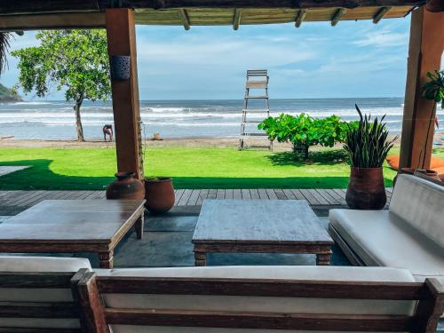 a porch with benches and a view of the beach at El Sitio Village in Playa Venao