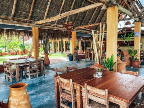 a dining room with a wooden table and chairs at El Sitio Village in Playa Venao