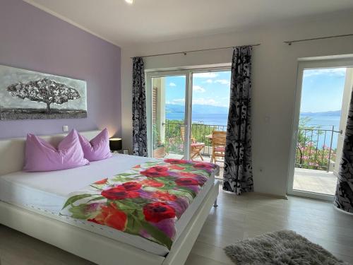 a bedroom with a bed with a large window at Apartments Gajeta in Povile