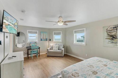 a bedroom with a bed and a chair and a table at Beachin' Good Time in Port Aransas