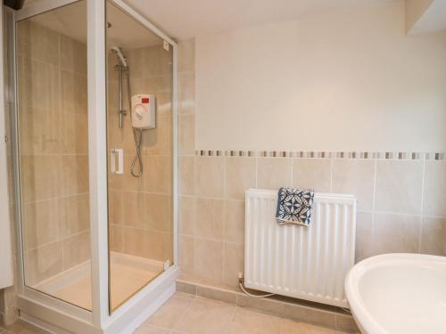a bathroom with a shower and a toilet and a sink at The Annexe in Soutergate