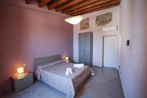 a bedroom with a bed with two lamps on it at Le Signorine Panoramic apartments in Gratteri