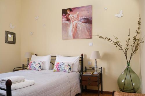 a bedroom with a bed and a painting on the wall at Batilas Garden House in Kissamos
