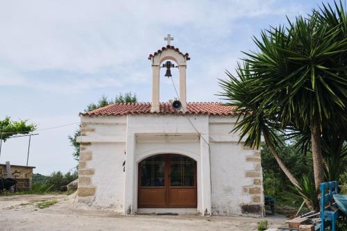 a small church with a cross on top of it at Batilas Garden House in Kissamos